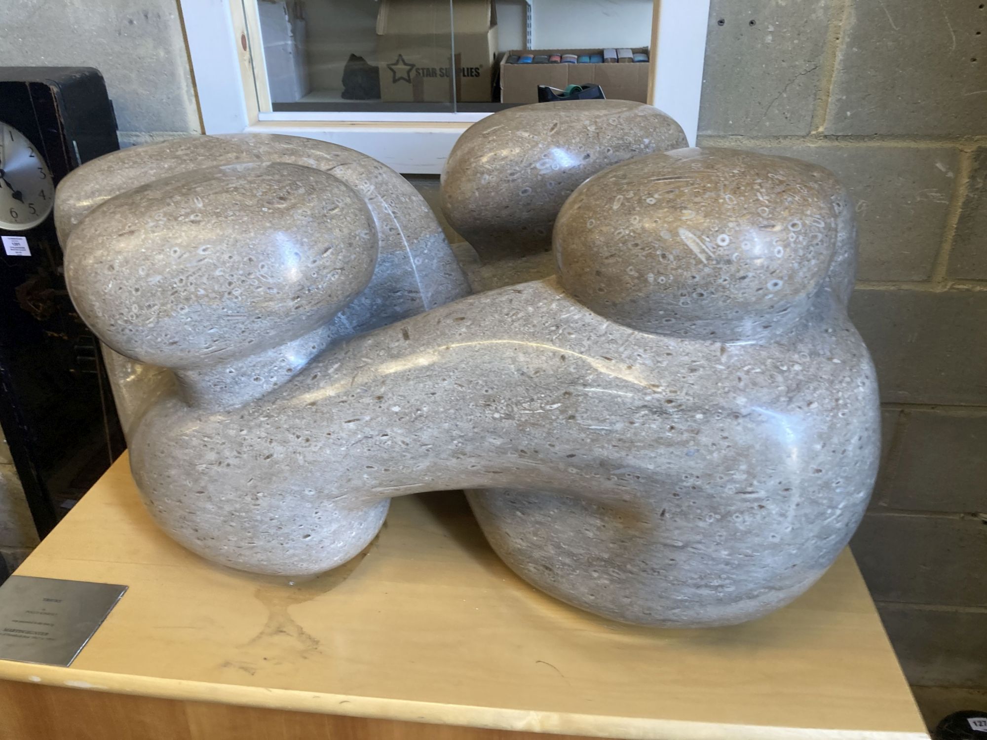 § Polly Ionides (born 1944) Triune, An abstract figural carved limestone group, width 106cm, depth 50cm, height 50cm